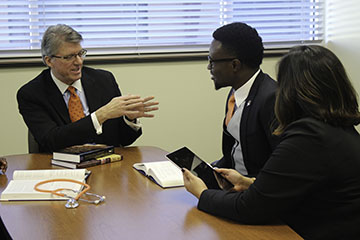 Dr. Jim Hess speaking with students