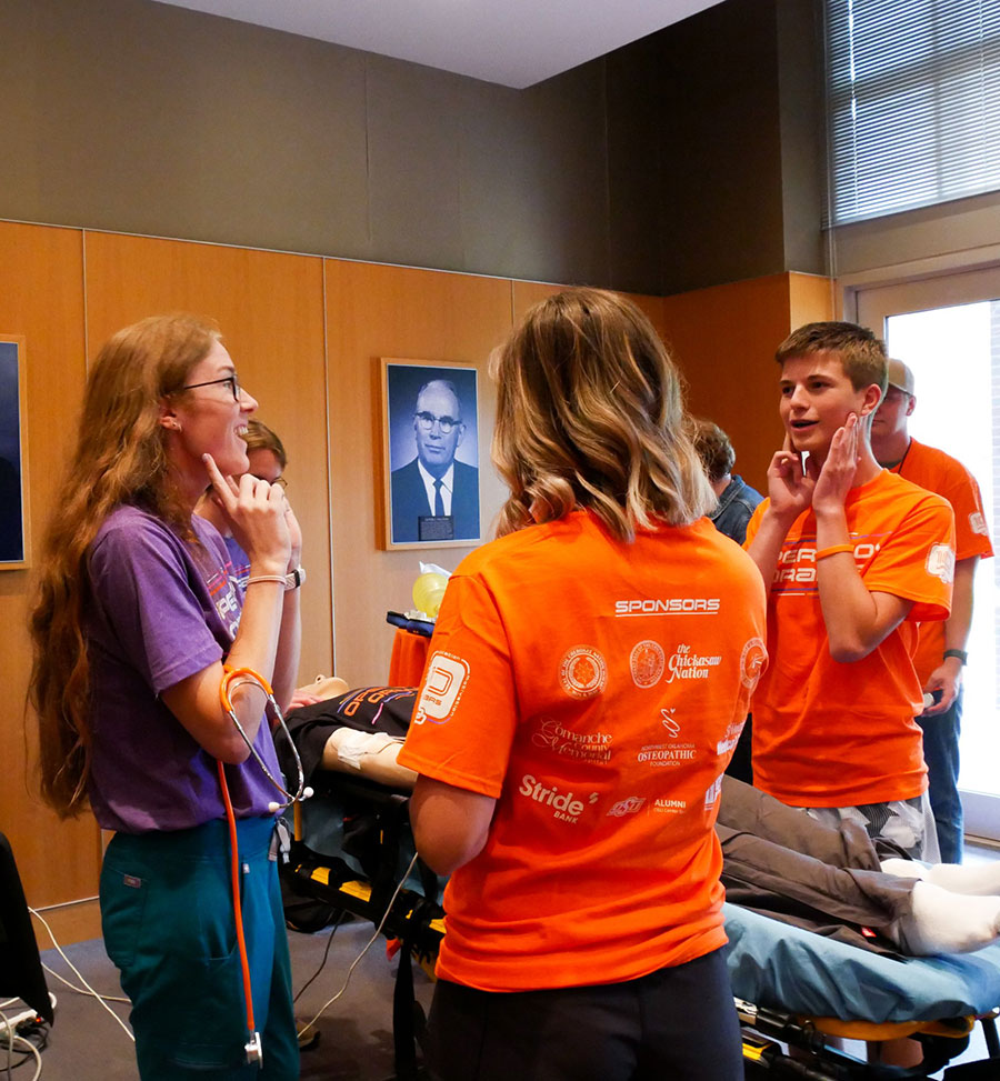 Student ambassadors working with high school students at Operation Orange.