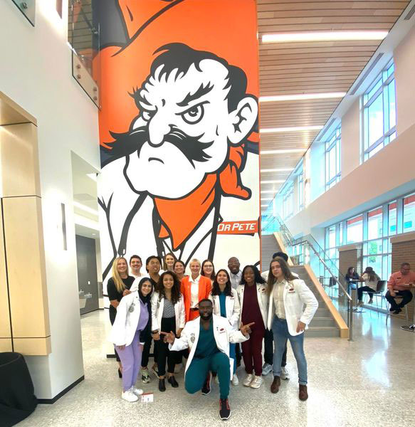 Student ambassadors show their OSU pride during the grand opening of the North Hall building.