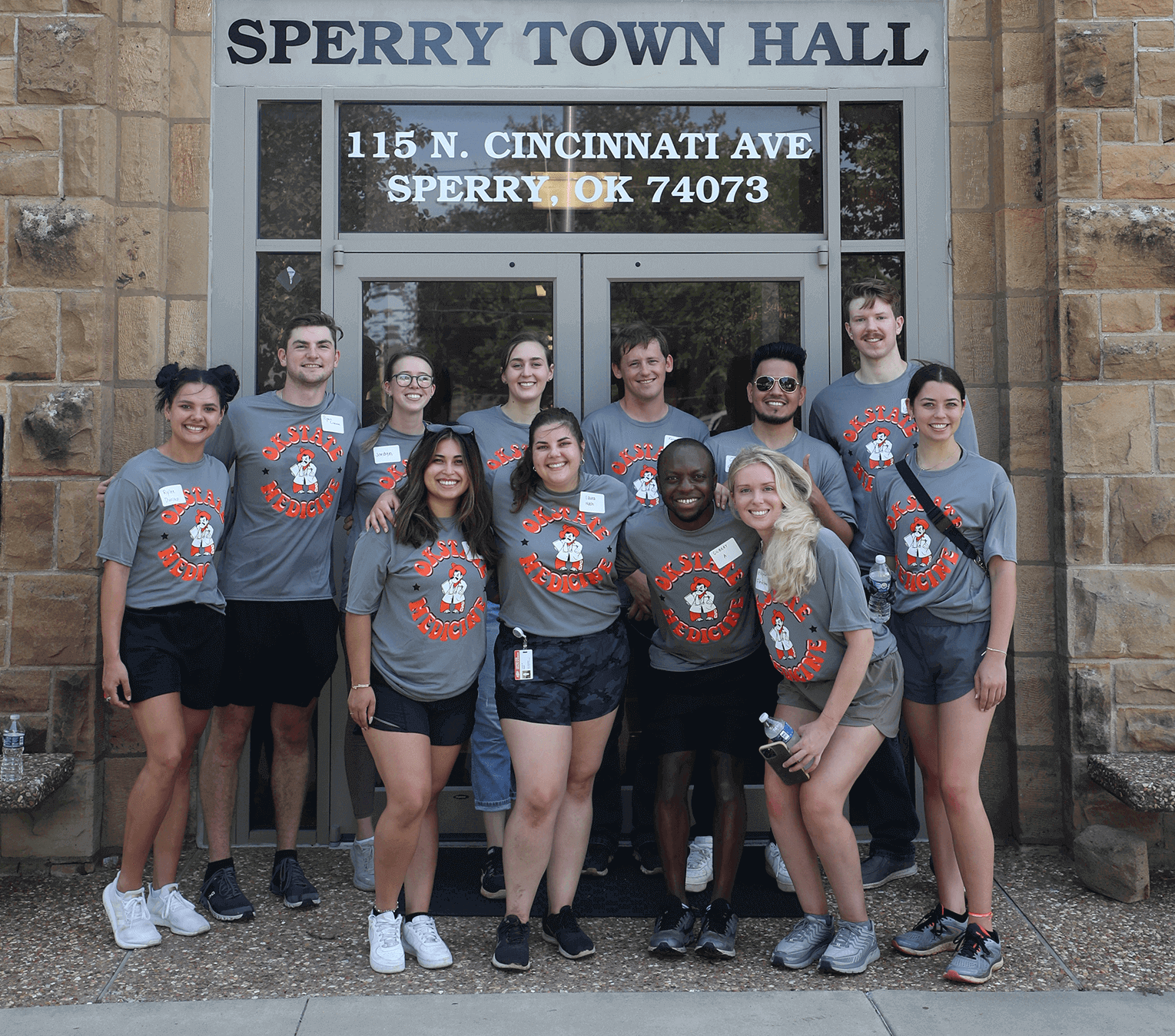 Medical students refreshing a flowerbed.