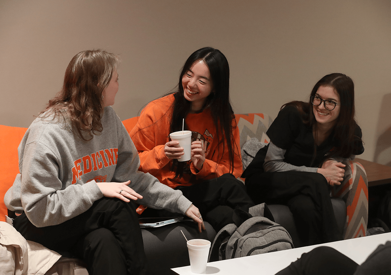 Medical students Karlyn Tanzey (left), Avery Lewis and Jordan Wilson (right) enjoy hot chocolate in the student center at the OSU Center for Health Sciences in Tulsa, Ok