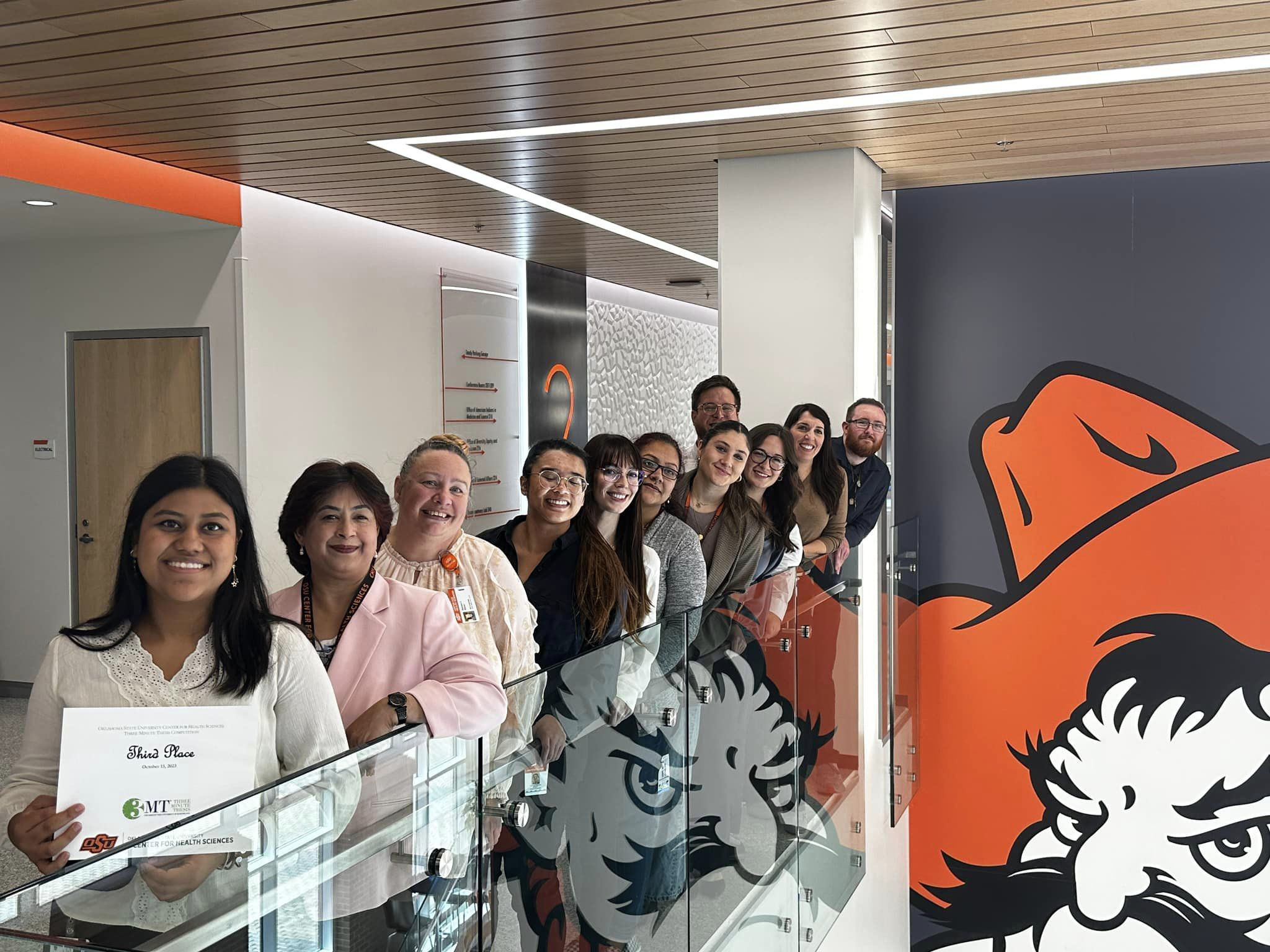 Medical students holding an award from a Three Minute Thesis competition.