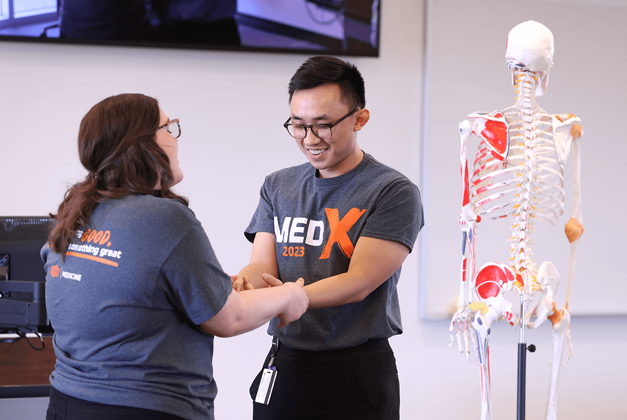 Medical students including Sarah Wilkinson (left) demonstrate Osteopathic manipulative medicine (OMM) during Med-X on the OSU Center for Health Sciences campus in Tulsa, OK.
