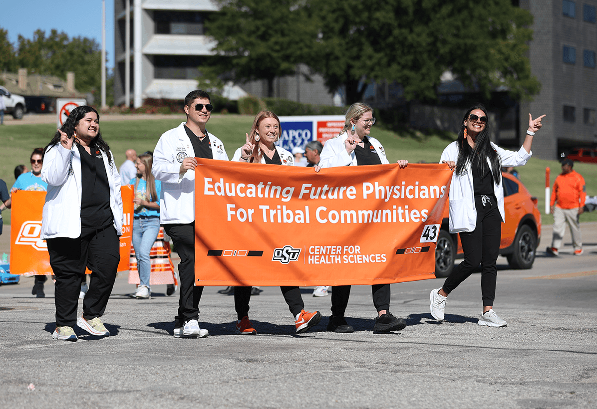 Members of NASOM (North American Society of Obstetric Medicine) march in the Native American Day Parade in Tulsa, Oklahoma.