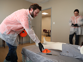 students running through a fake investigation with dummy