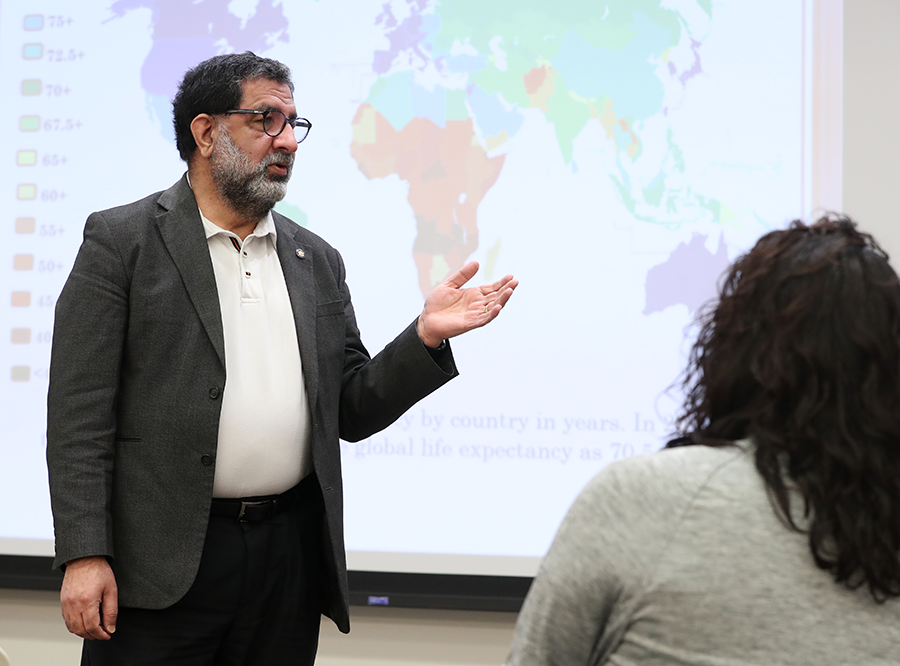 Professor with global health map in background