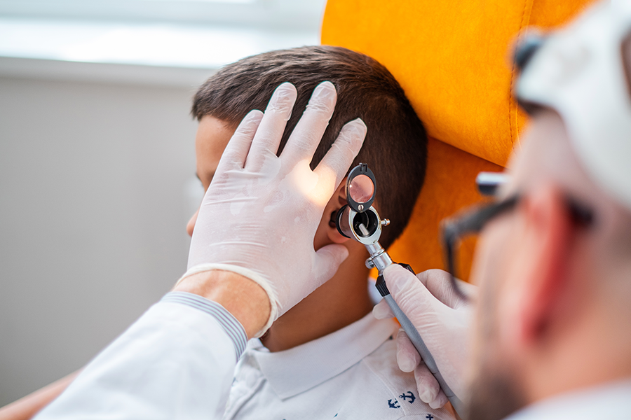 doctor looking into a childs ear