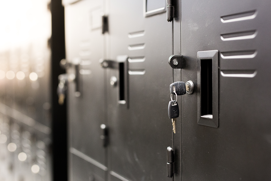 Close up of black lockers with keys in keyhole