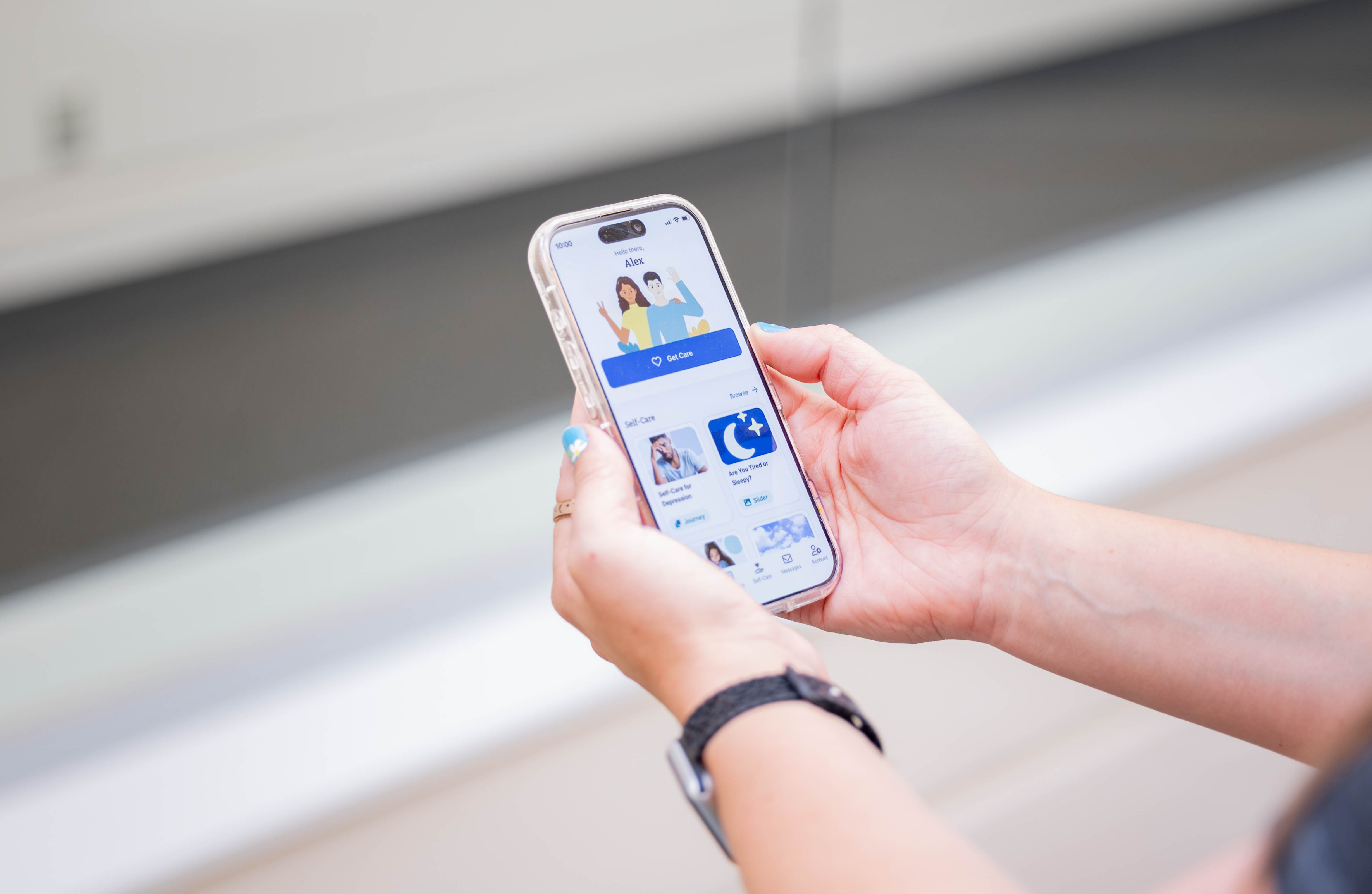 A pair of hands holding a smart phone on the TimelyCare app.